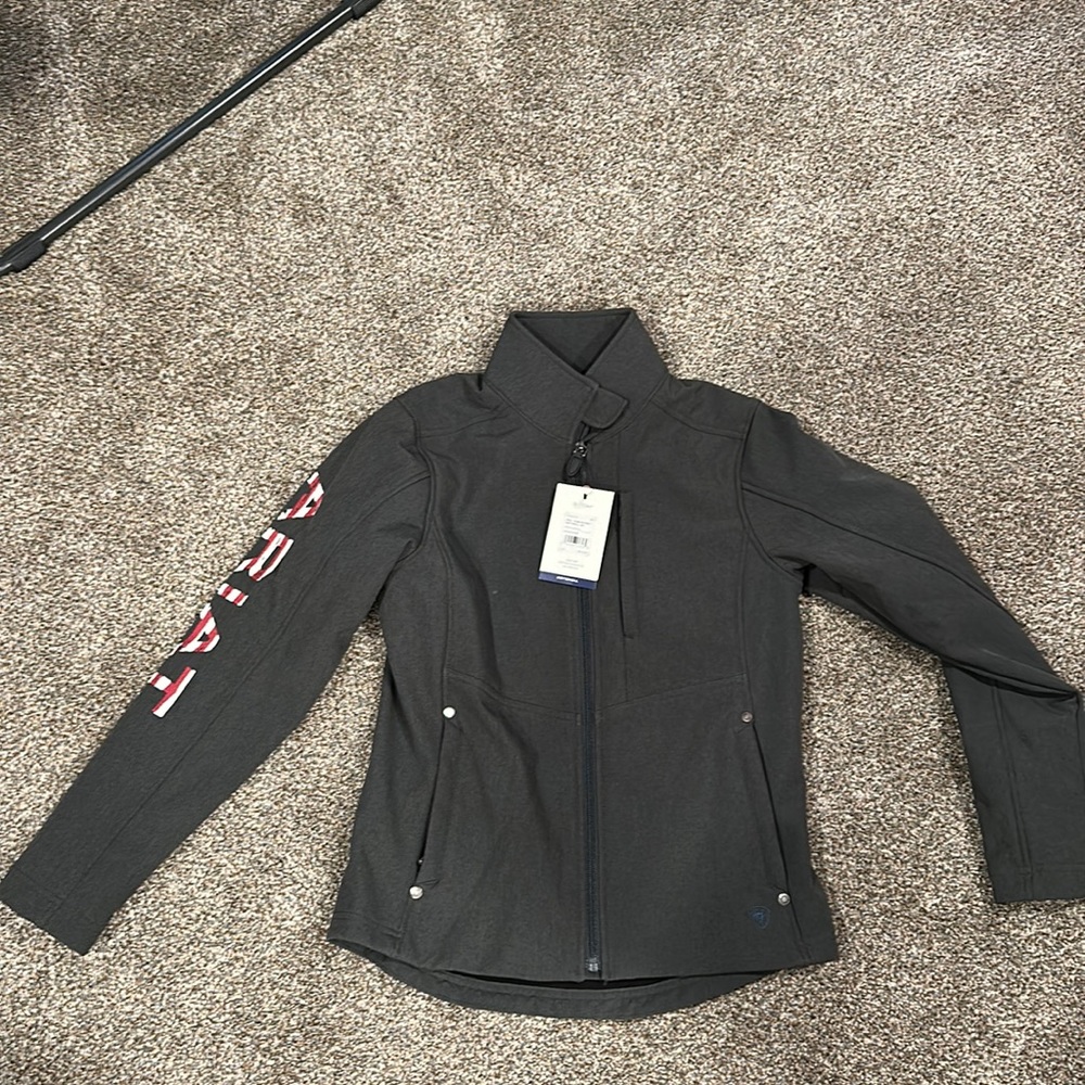 Arias soft shell coat with concealed carry pocket. American flag design on back.